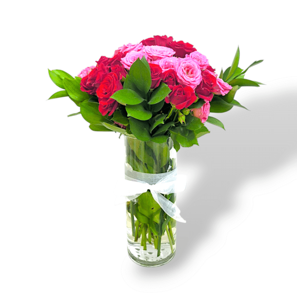 Red and pink rose bouquet in glass vase, 24 fresh roses with green leaves, romantic mixed rose arrangement, elegant floral centerpiece, fresh roses decor